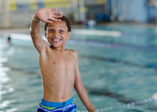 Boy Waving After Swim At YMCA Lap Pool