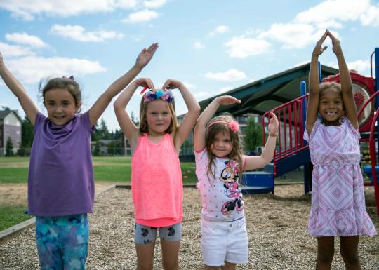 Child Care Kids on Playground Signing YMCA