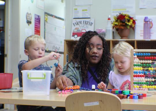 ELC staff playing with two children