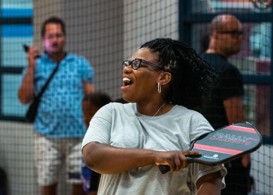 Woman post swing on the pickleball court