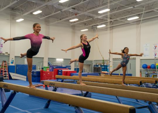 High beam practice at gymnastics clinic
