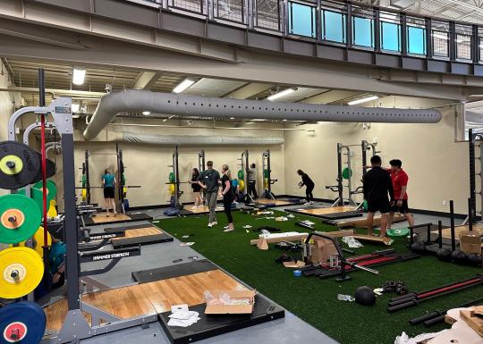 YMCA staff work to set up a renovated work out area
