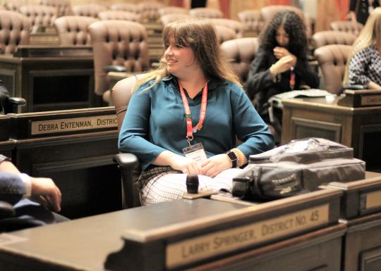 Youth and government student engaging in political discussion in the capitol building