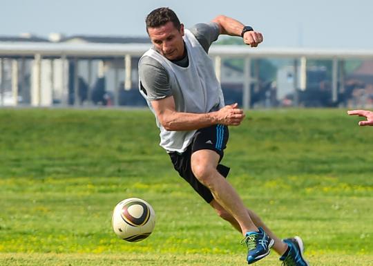 Action shot of an adult soccer game.