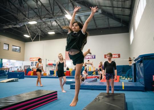 Action shot of recreation gymnast about to perform a round off at the YMCA