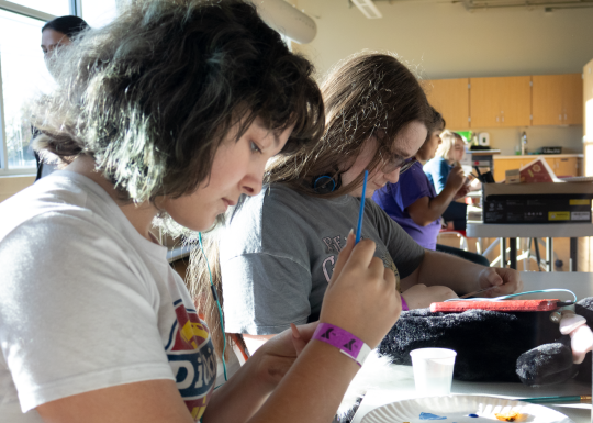 YLDC students work on a painting project at the YMCA