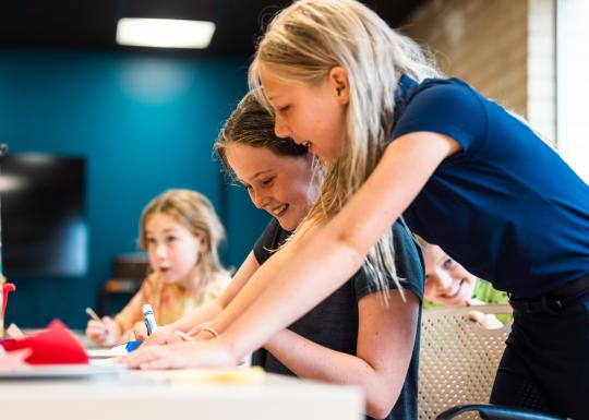 Art students draw with markers during art session time at the YMCA