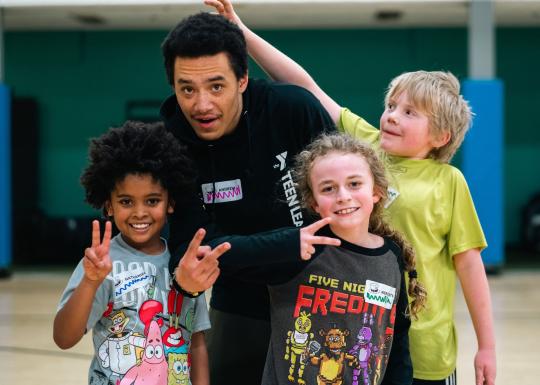 Kids night out group poses with peace signs at the YMCA