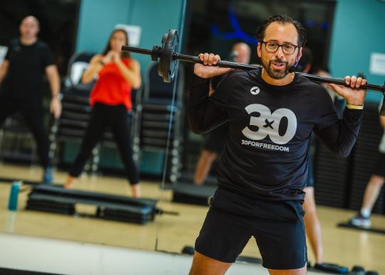 High intensity workout instructor leading class at the YMCA