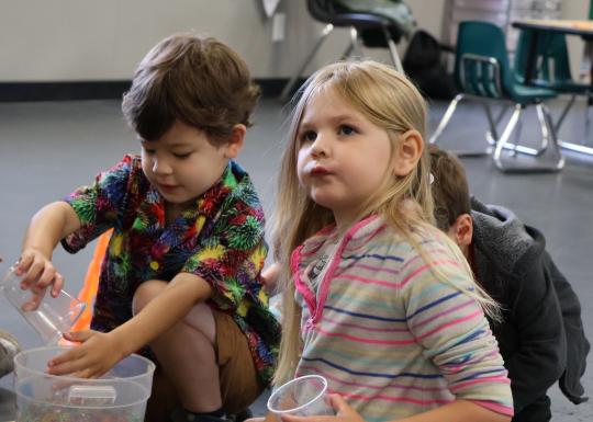 Y Camp campers participate in a game in the classroom.