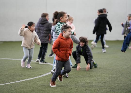 Break camp participants enjoying a game of soccer on the covered turf at the YMCA