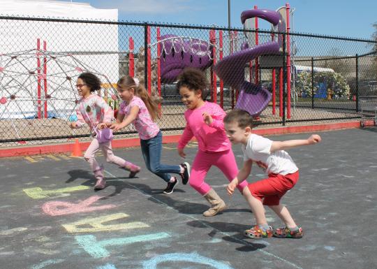 Action shot of Healthy Kids Day participants starting to run the fun run at the YMCA