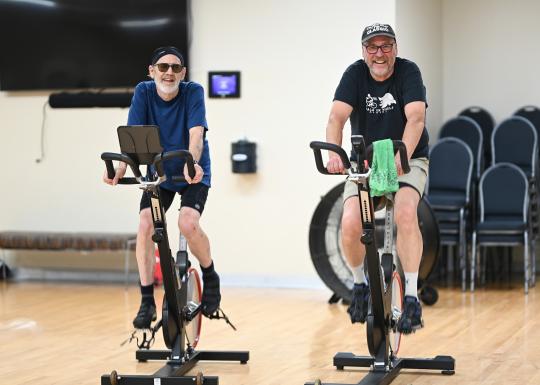 Two Friends Cycling in YMCA Spin Class