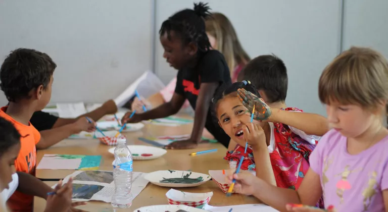 Action shot of an afterschool painting session at the YMCA