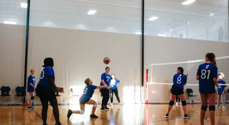 Action shot of a youth volleyball game at the YMCA