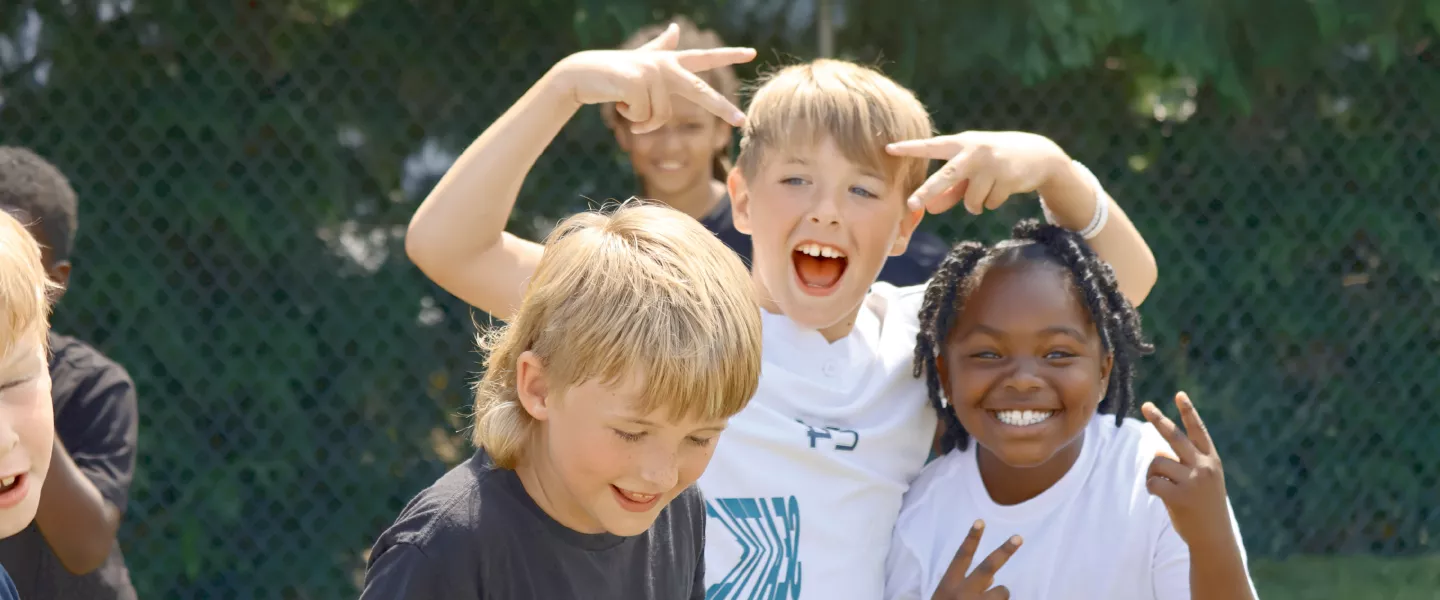 Summer camp participants pose for a photo during outside time at the YMCA
