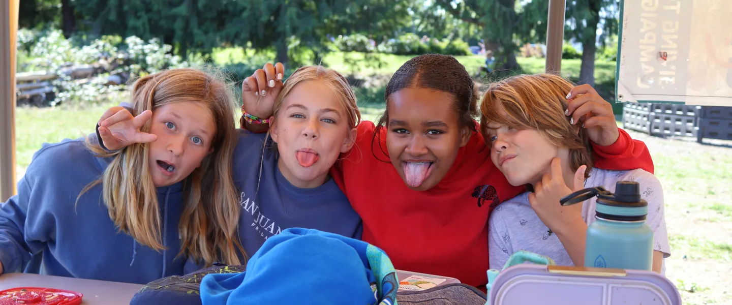 Campers pose for a picture during lunchtime at camp at the YMCA
