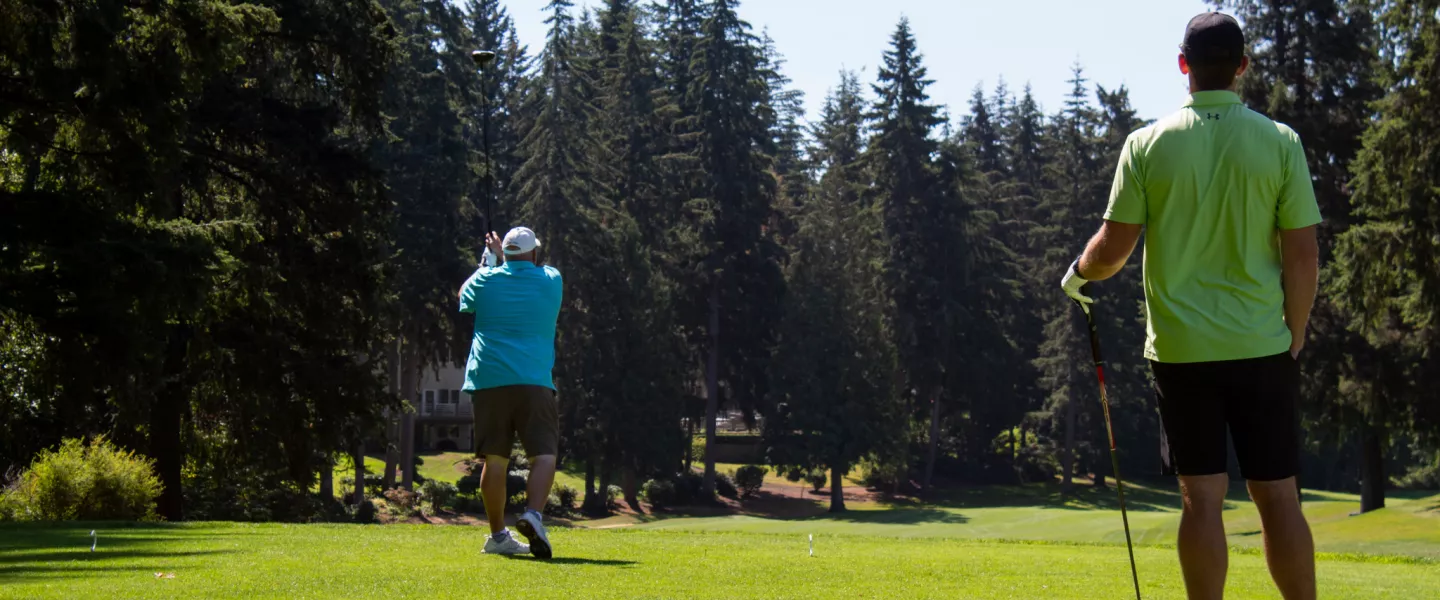 Action shot of a donor teeing off at the YMCA Annual Golf Tournament