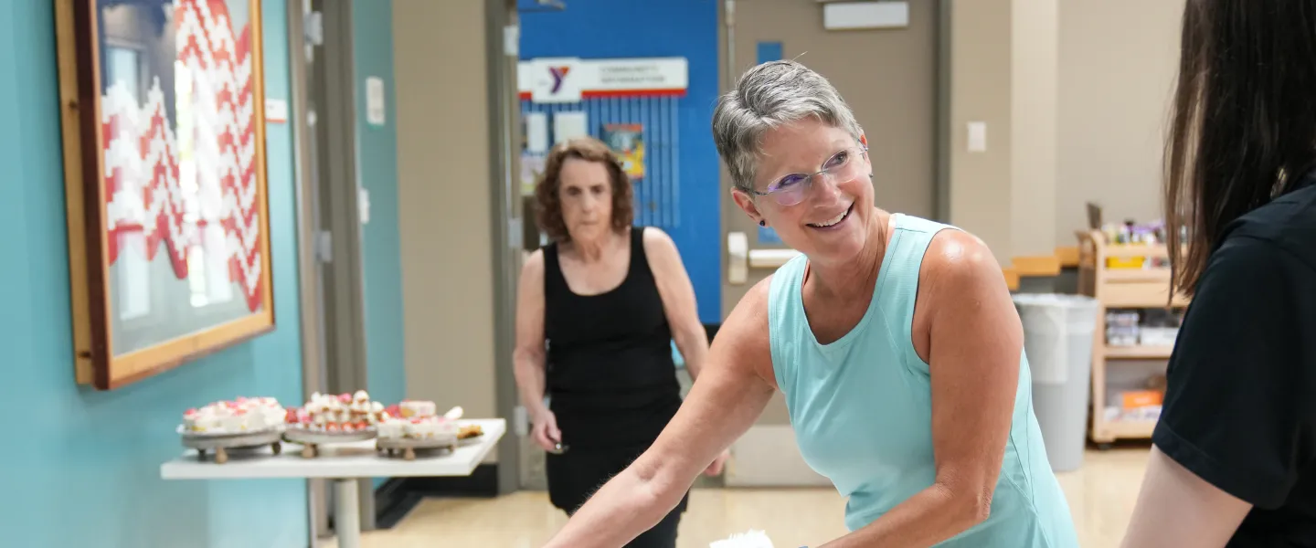Shot of a member grabbing food during the potluck at the Mel Korum Family YMCA