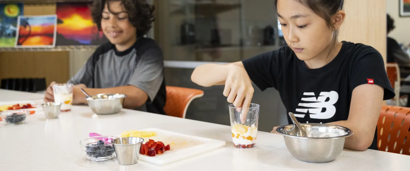 Culinary students assemble parfaits during class at the YMCA