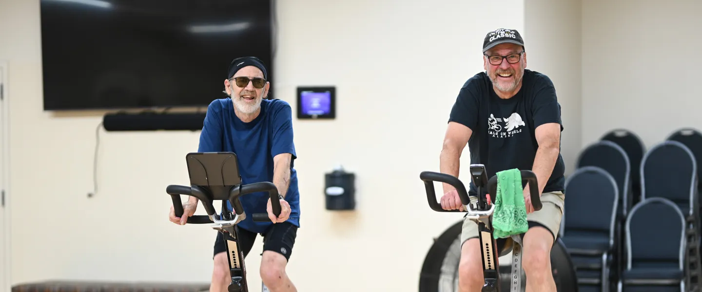Two Friends Cycling in YMCA Spin Class