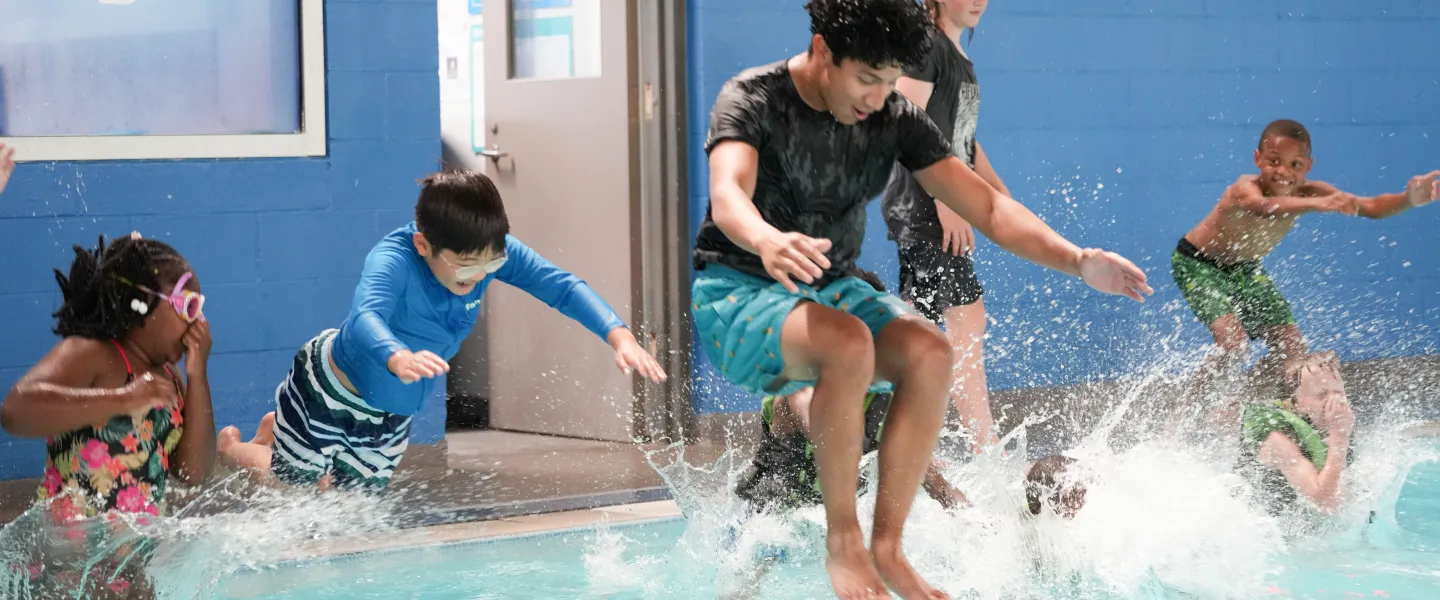 Kids jump in the pool at Y Camp at the YMCA