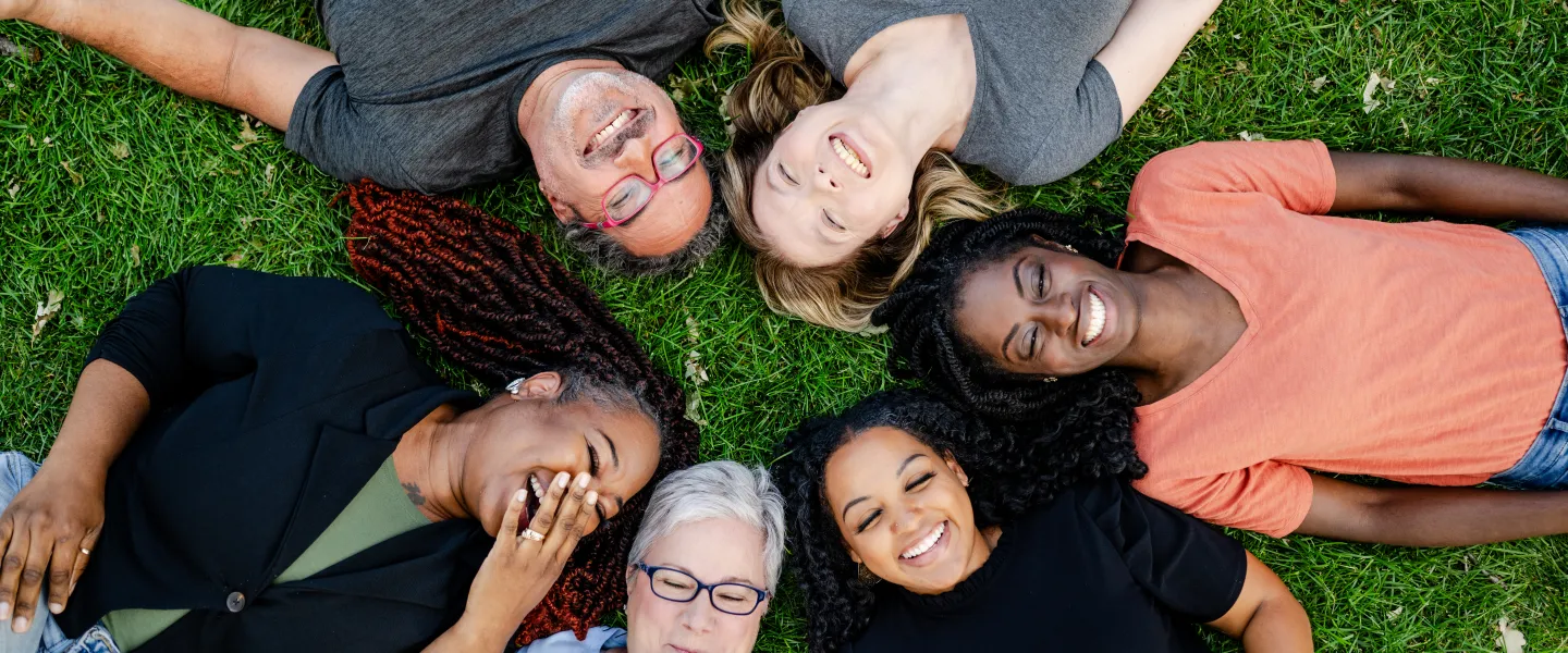 Happy people laying on the grass
