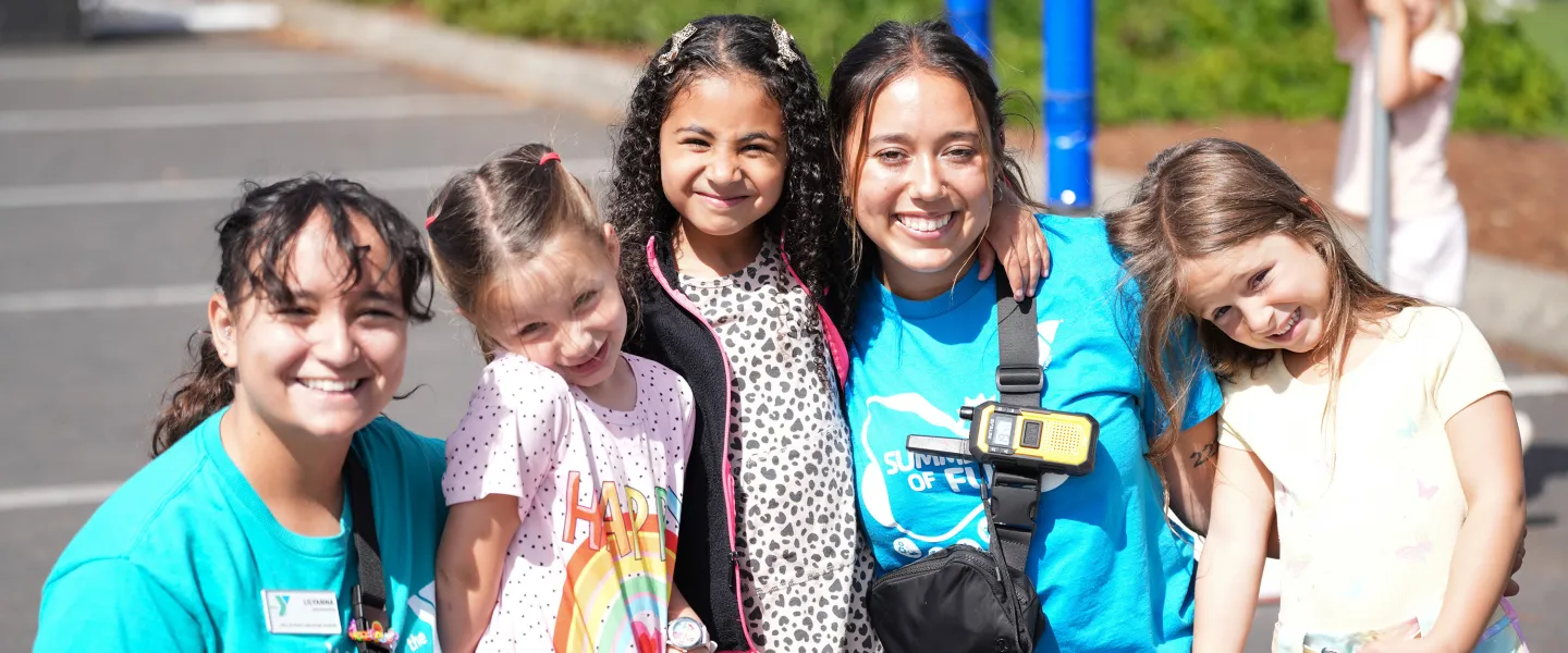 Two Conselors Smiling with Summer Campers at the Gordon Family YMCA