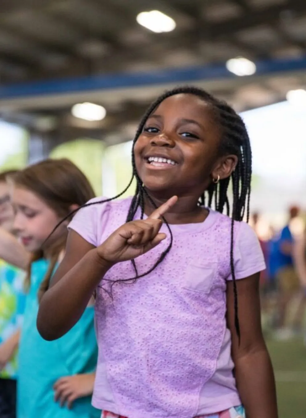 Summer camp participant celebrates a victory during game time at the YMCA