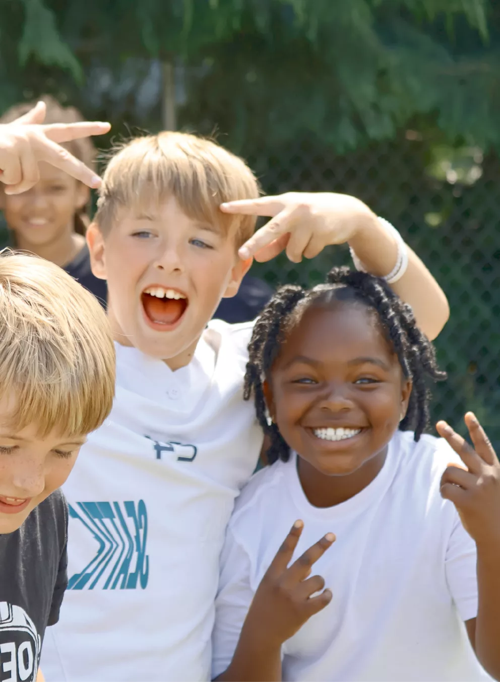 Summer camp participants pose for a photo during outside time at the YMCA
