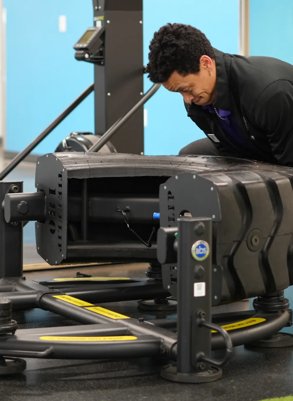 Action shot of someone using the tire flip machine at the YMCA