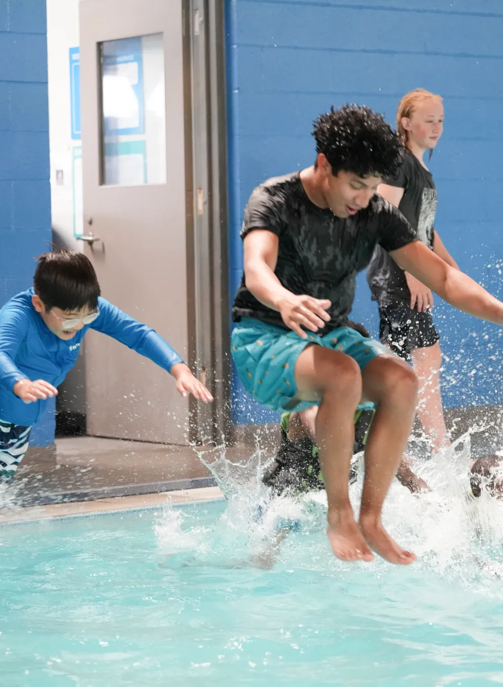 Kids jump in the pool at Y Camp at the YMCA