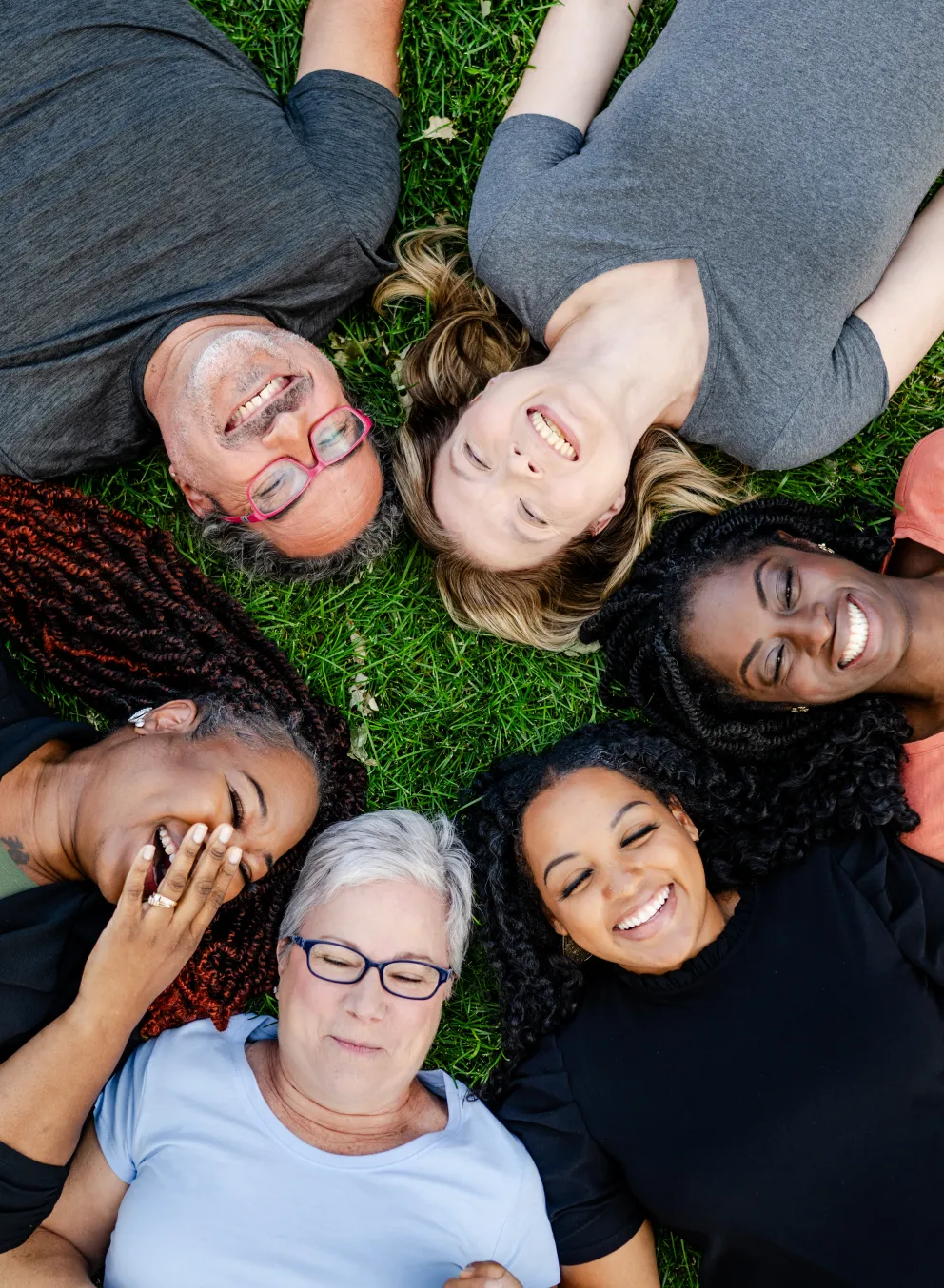 Happy people laying on the grass