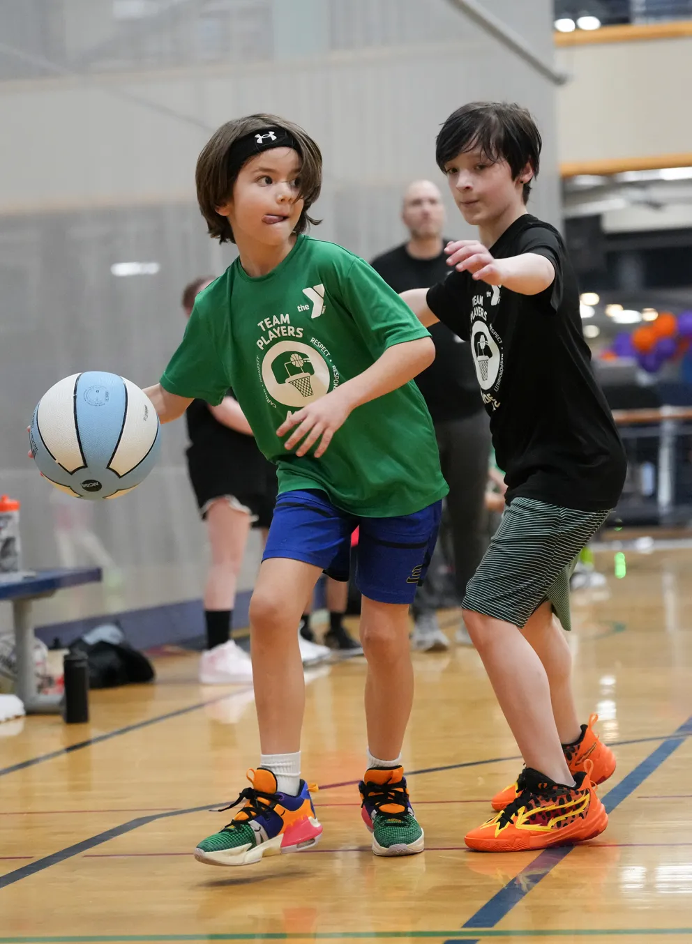YMCA Youth Basketball Player Concentrating on the Court with Defender