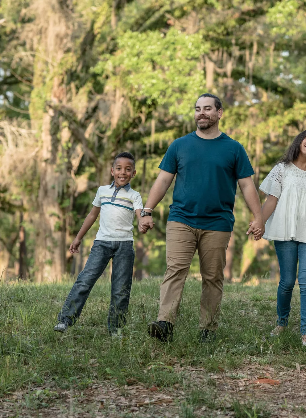 Family Holding Hands In The Park