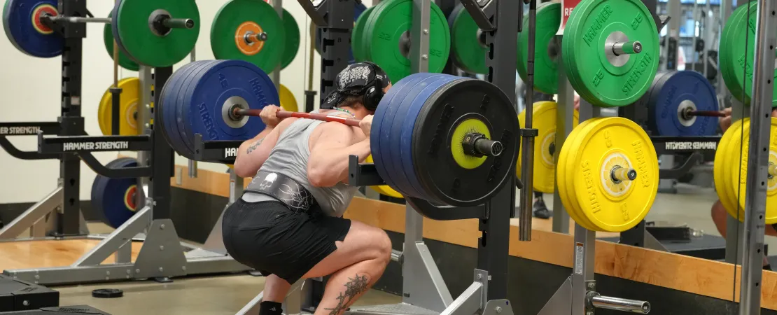 Action shot of someone using the new squat rack at the YMCA