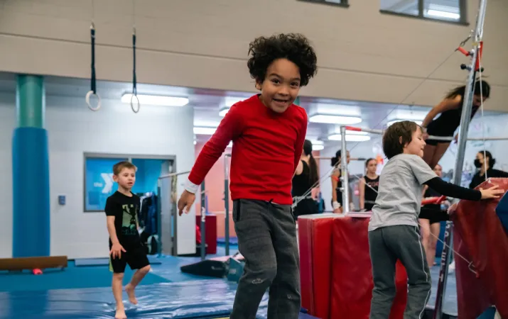 Boy in Red Jumping at YMCA Gymnastics