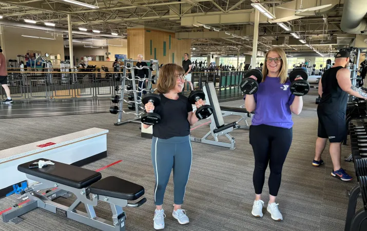 Jaclyn and Katie performing bicep curls
