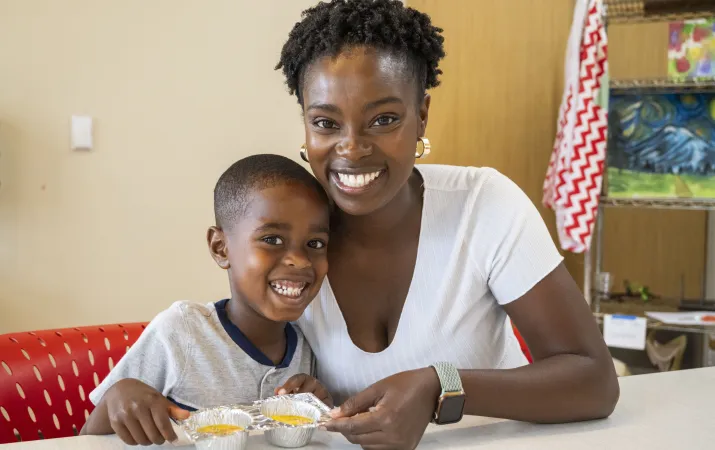 Shot of a mother and son showing off their culinary creations at the YMCA