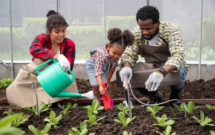 Family Watering the Garden Together