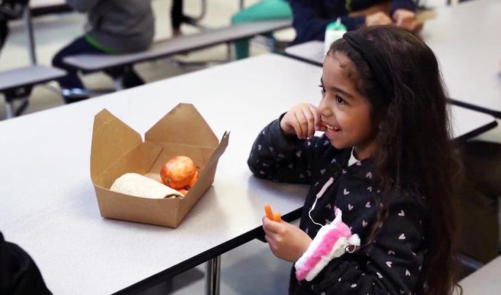 YMCA Child Care Participant Eats Lunch