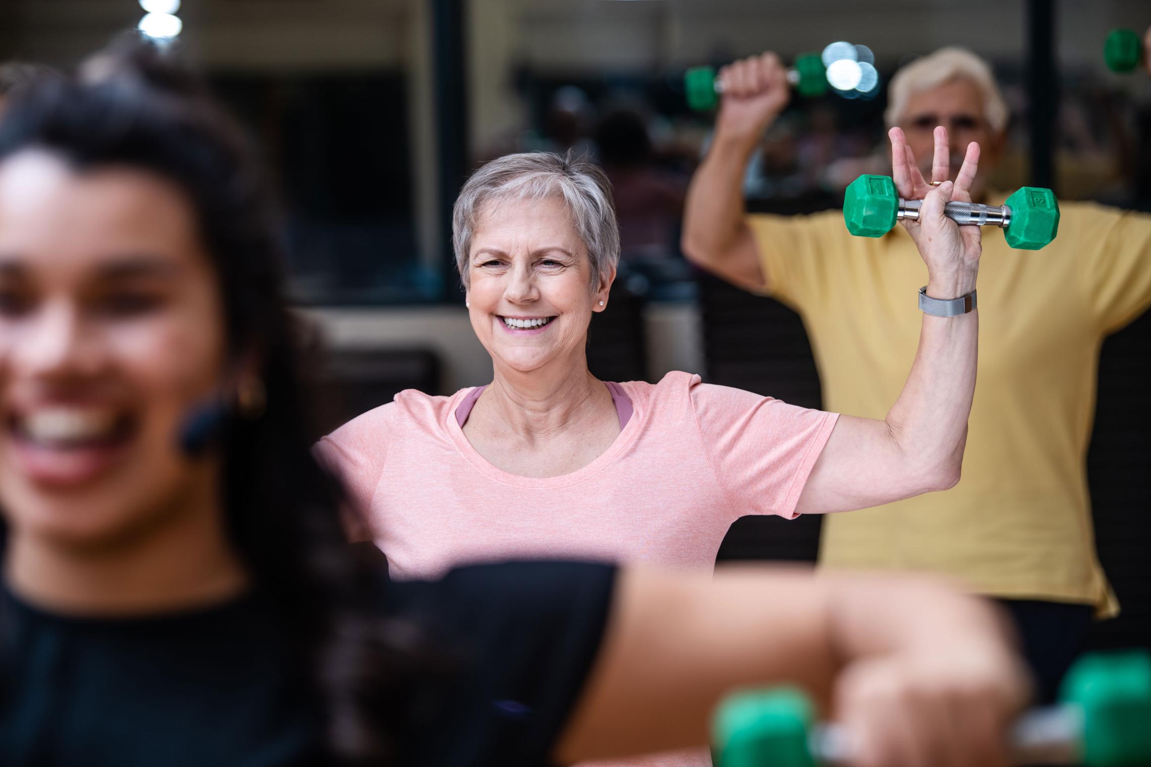 Active Older Adults Shoulder Press In YMCA Group Exercise Class