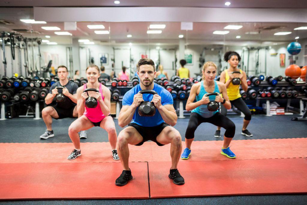 Squatting In YMCA Kettlebell Group Exercise Class