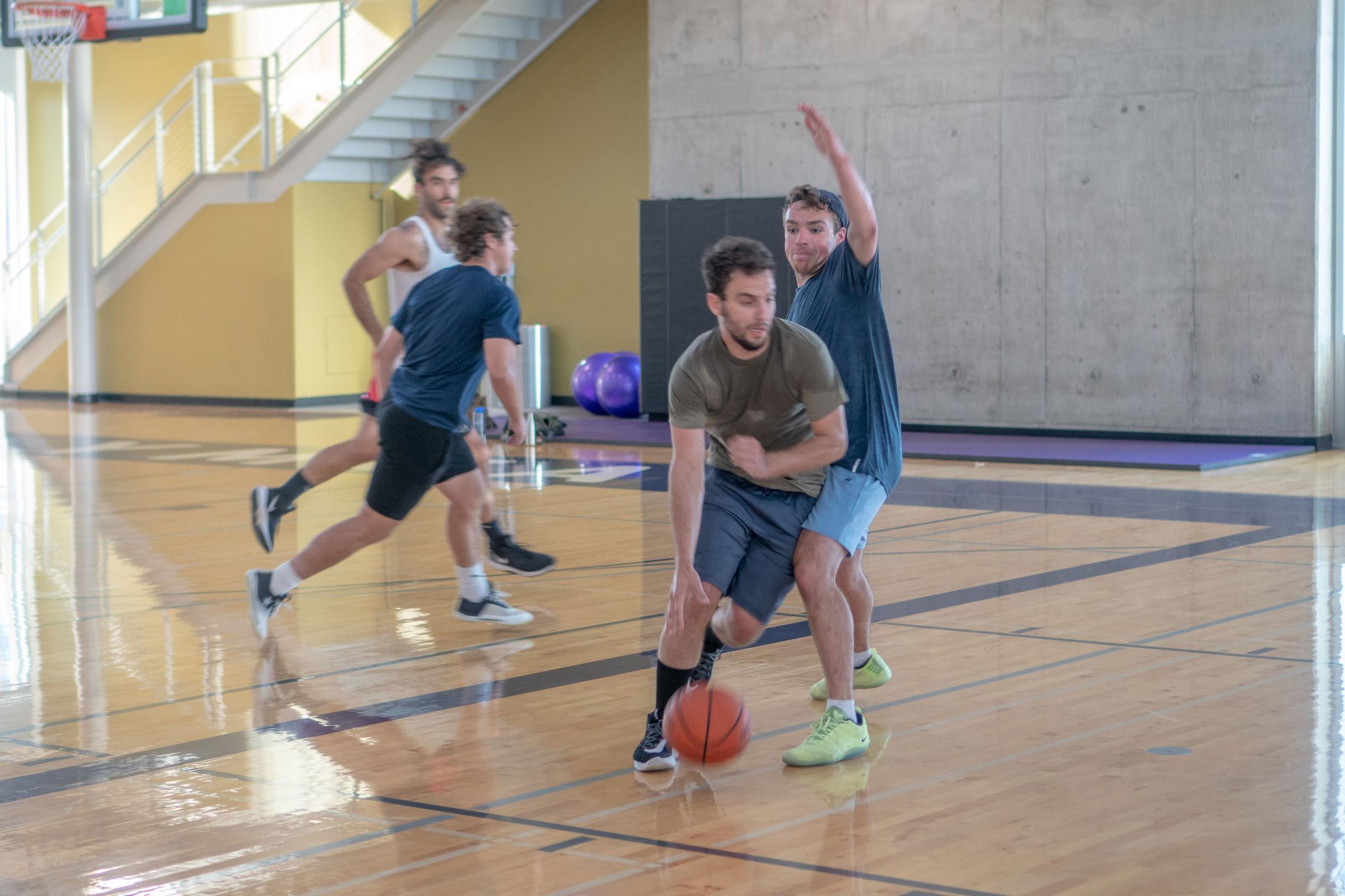 Group Playing Basketball At Their Local YMCA
