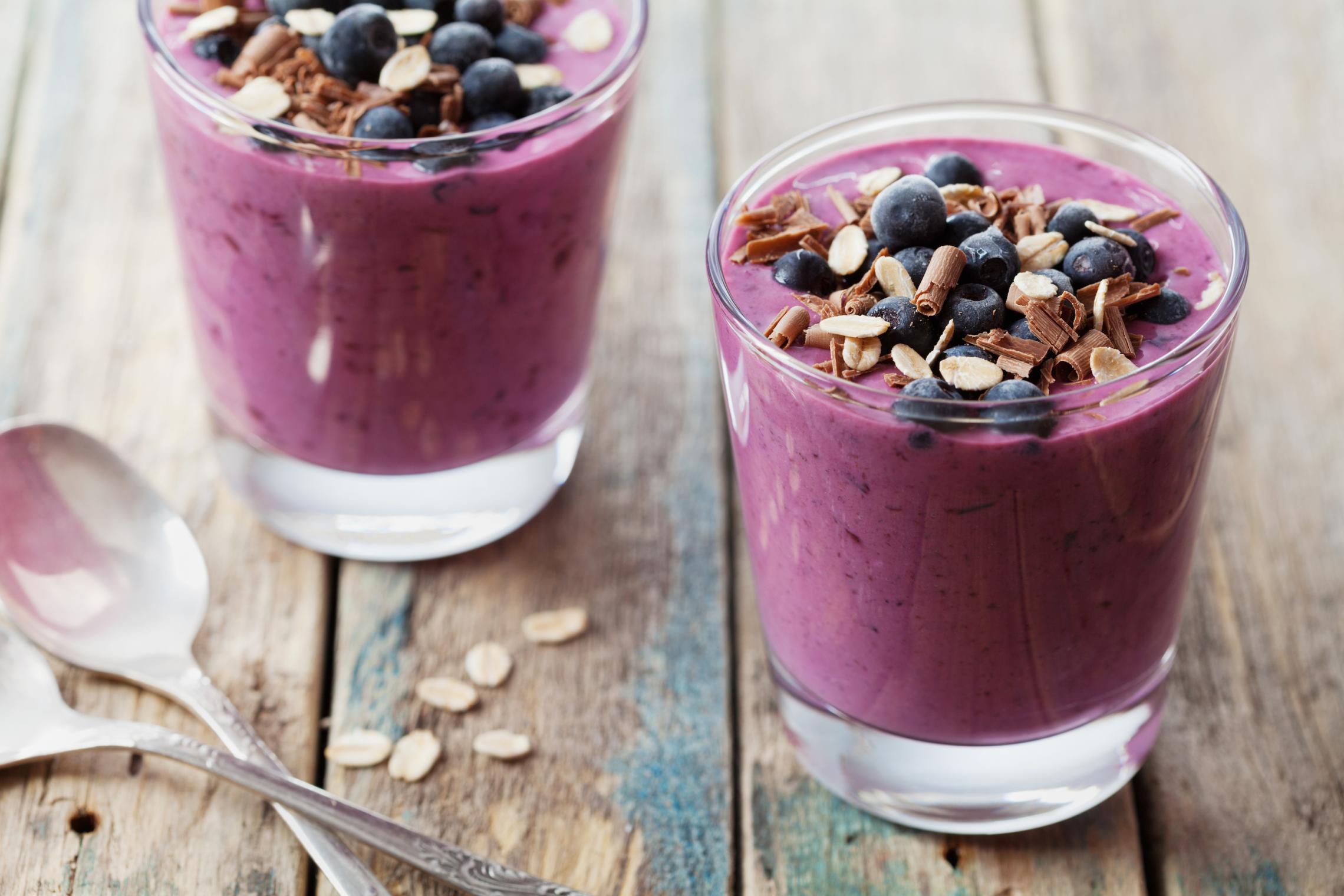 Two fruit smoothies with oats on a table