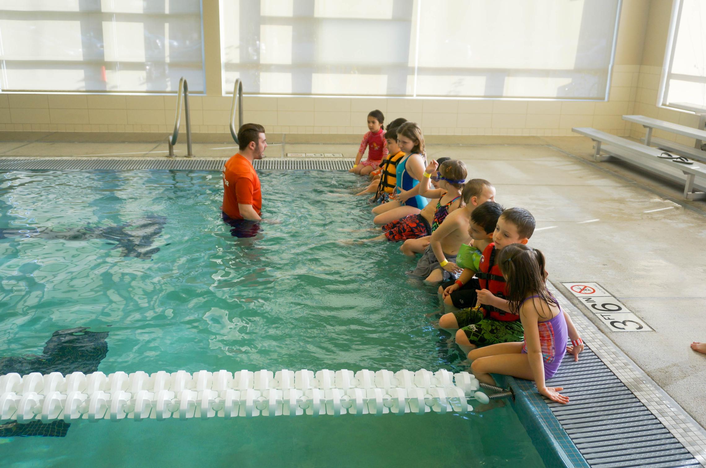 Winter break camp swim students lined up for instruction