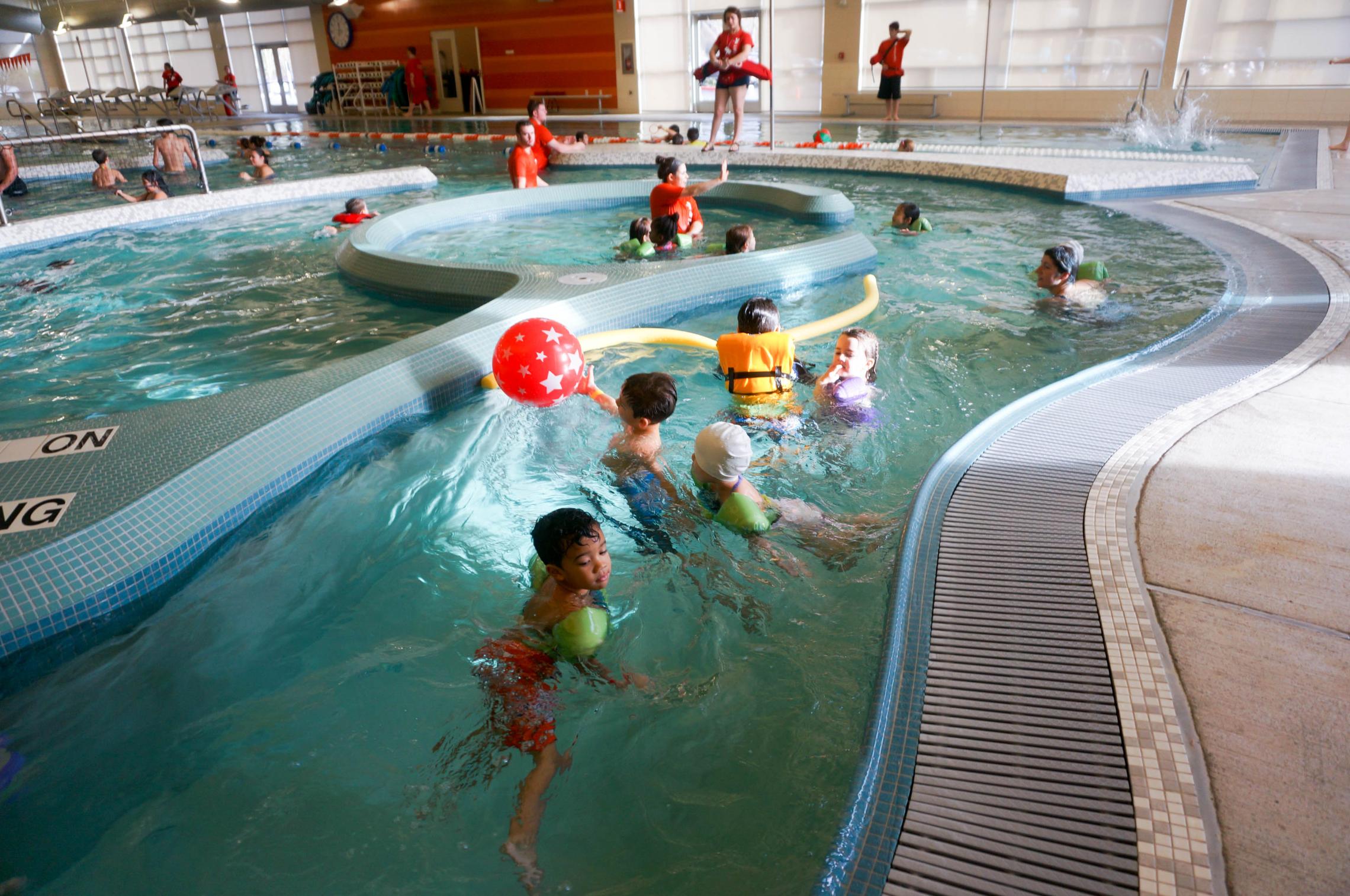 Winter break camp participants enjoying lazy river under aquatic staff supervision