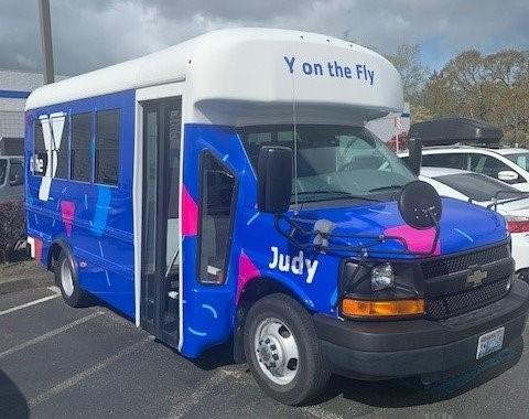 Judy the bus wrapped in Y branding and parked at Lakewood Family Y.