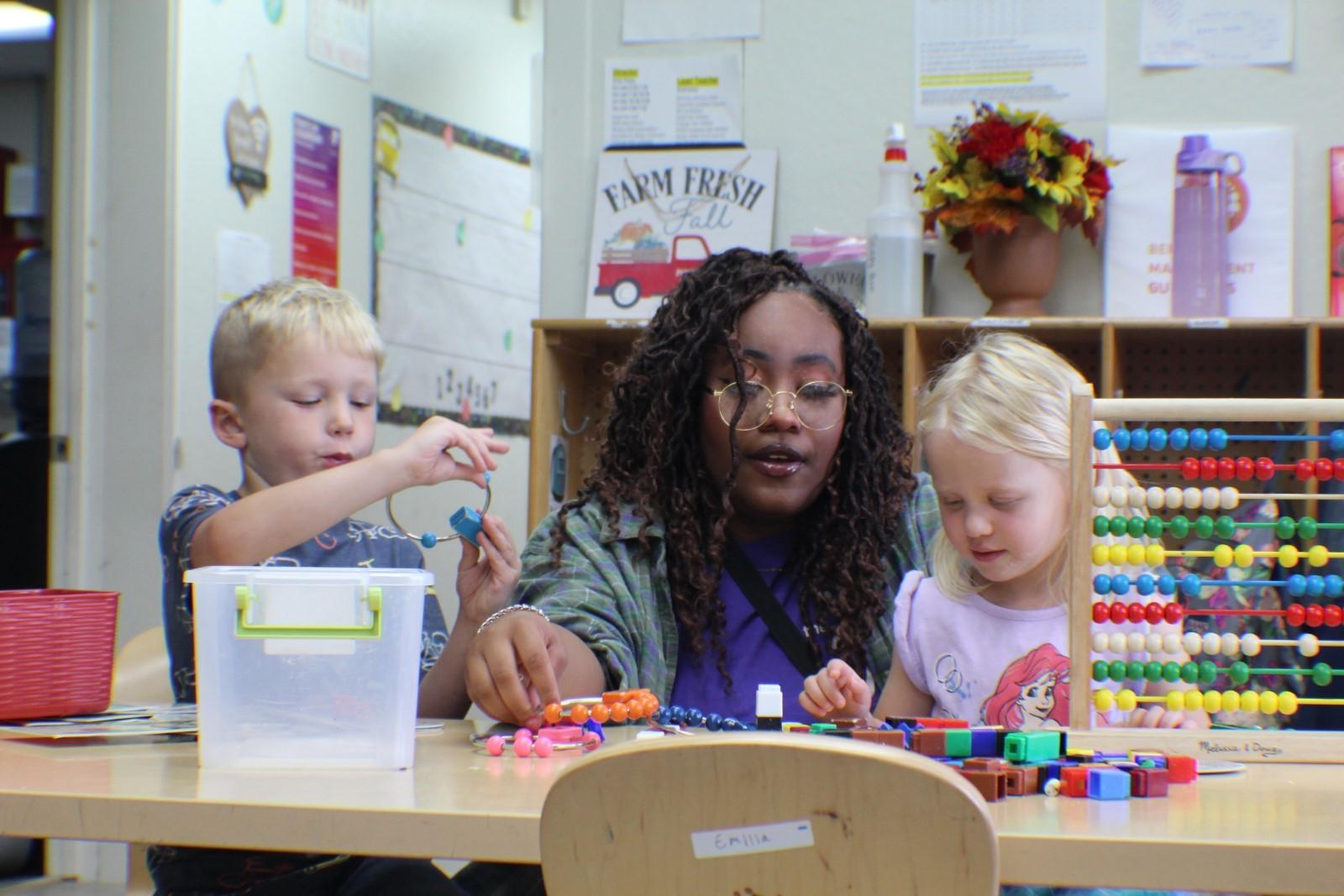 ELC staff playing with two children