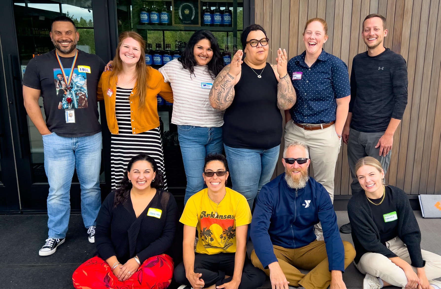 South South YMCA team members smile in two rows to celebrate the partnership with YMCAPKC to expand the reach of the Bridge of Hope initiative.